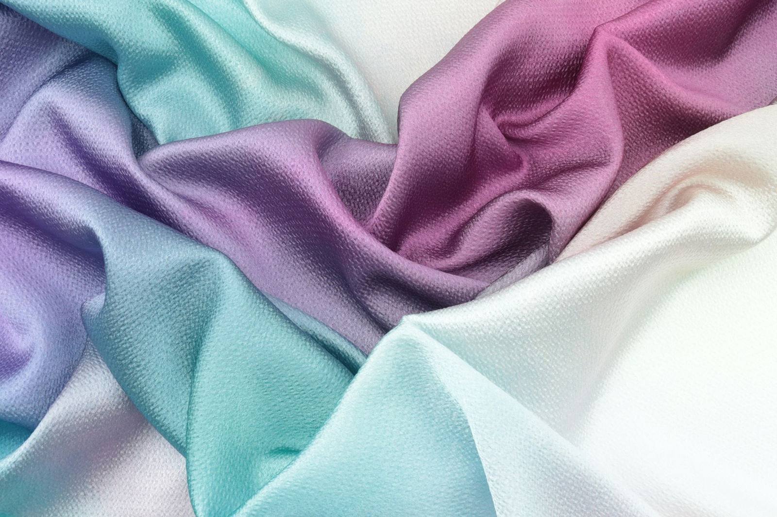 Flowing premium fabric in teal, violet and magenta gradients