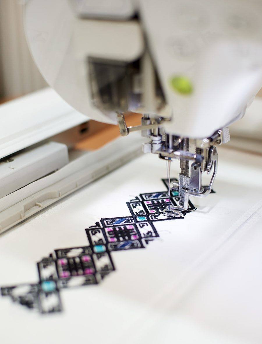 Computerised embroidery machine stitching a pattern